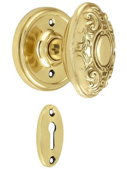 Classic Rosette Mortise Lock Set With Decorative Oval Knobs in Polished Brass.